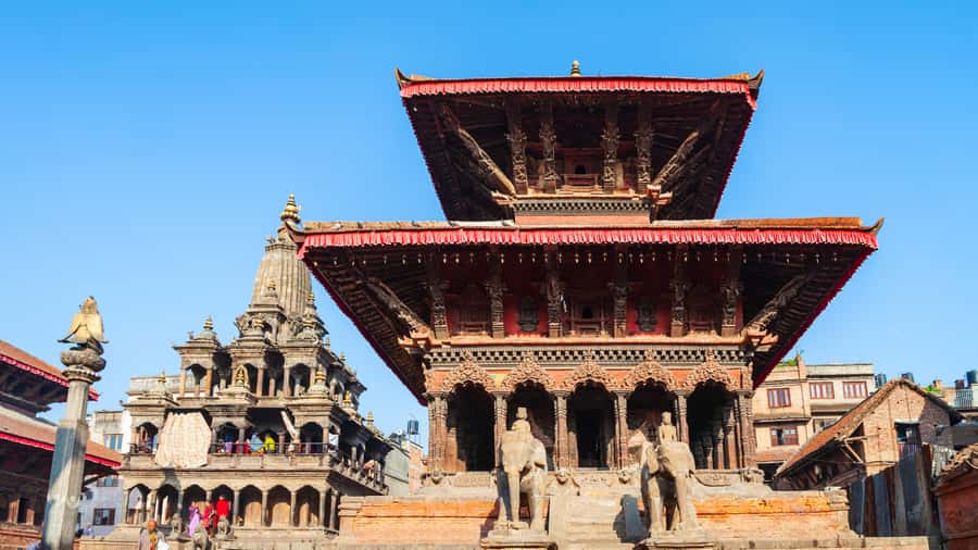 Kathmandu: Private Patan and Bhaktapur Sightseeing Tour - Entering Patan Durbar Square: courtyards, temples, and royal-era details
